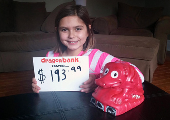 Child holding a sign that says how much they saved with DragonBank