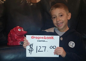 Child holding a sign that says how much they saved with DragonBank